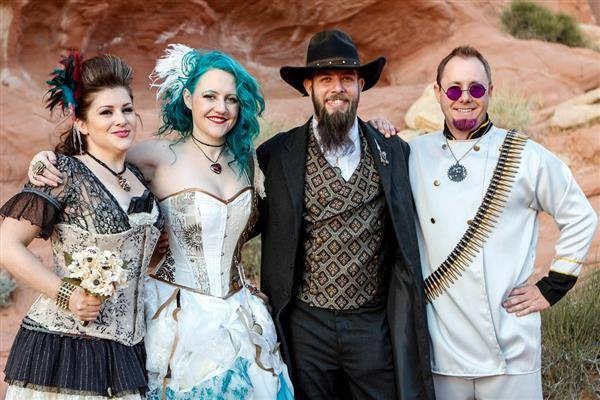 Steampunk couple with colourfully dressed wedding guests