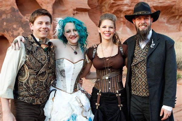 Bride, groom and two guests all dressed in steampunk outfits