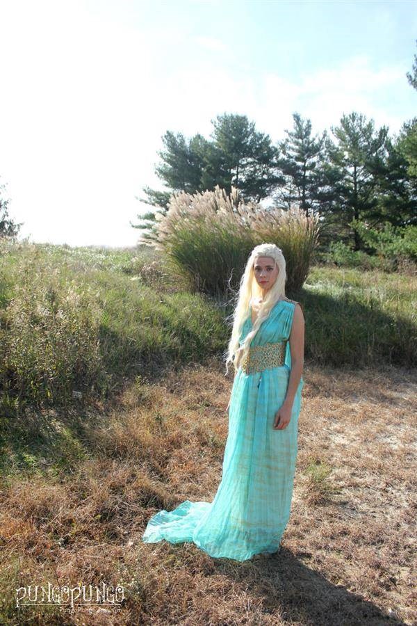 Girl outdoors in cosplay Kaleesi dress and wig