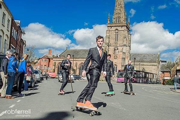 Groom and his groomsmen skateboarding through Hereford to his wedding