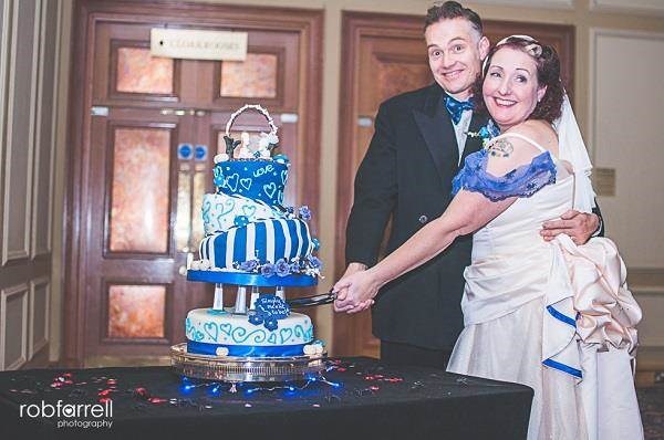 Happy couple cutting an unconventional wedding cake