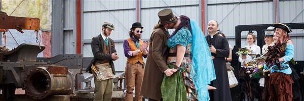 Steampunk wedding, bride and groom kiss