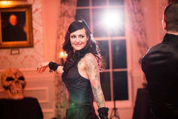 Tattooed bride dancing at her Halloween wedding reception