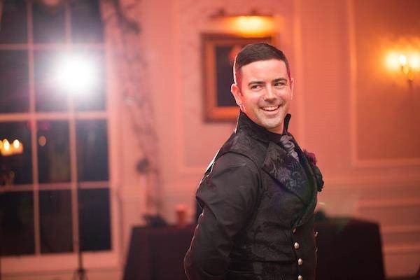 Gothic groom dancing at his Halloween wedding reception