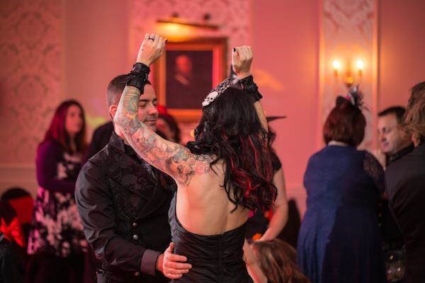 Tattooed bride dancing with her new husband