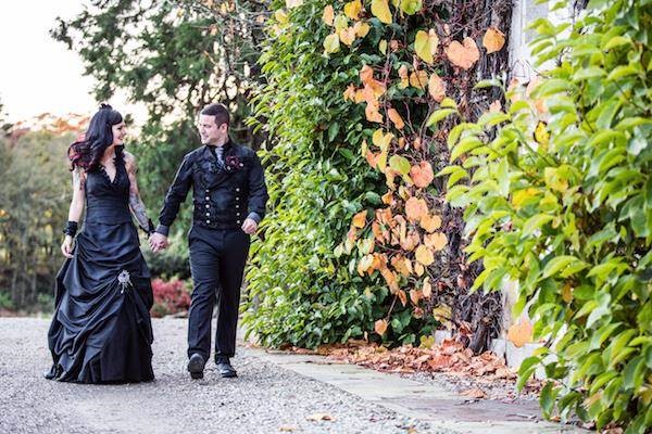 Gothic bride and groom taking a stroll at their Halloween wedding