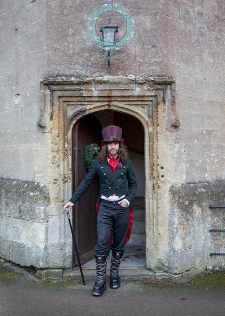 Groom in full Gothic attire at a castle wedding.