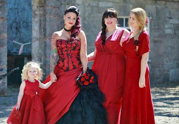 The bride and bridesmaids at her red and black themed wedding.