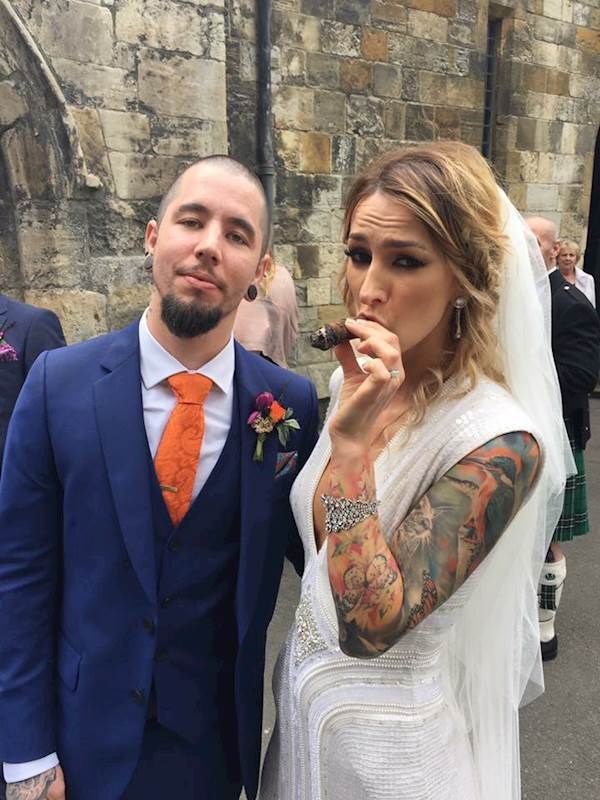 Tattooed bride relaxing with a cigar!