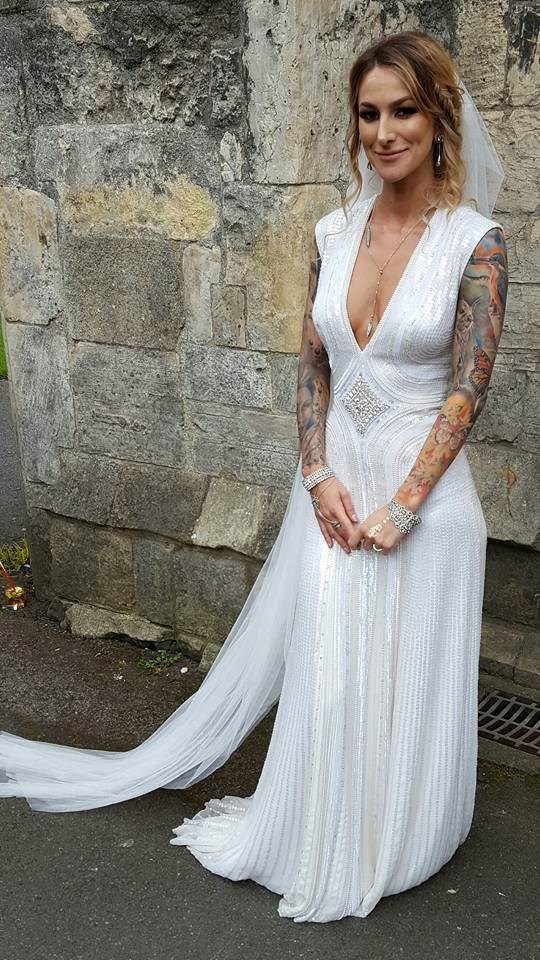 Tattooed bride in beautiful white dress.