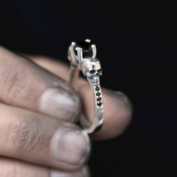 Unique alternative engagement ring with skulls and black stones from Nataly Avirame